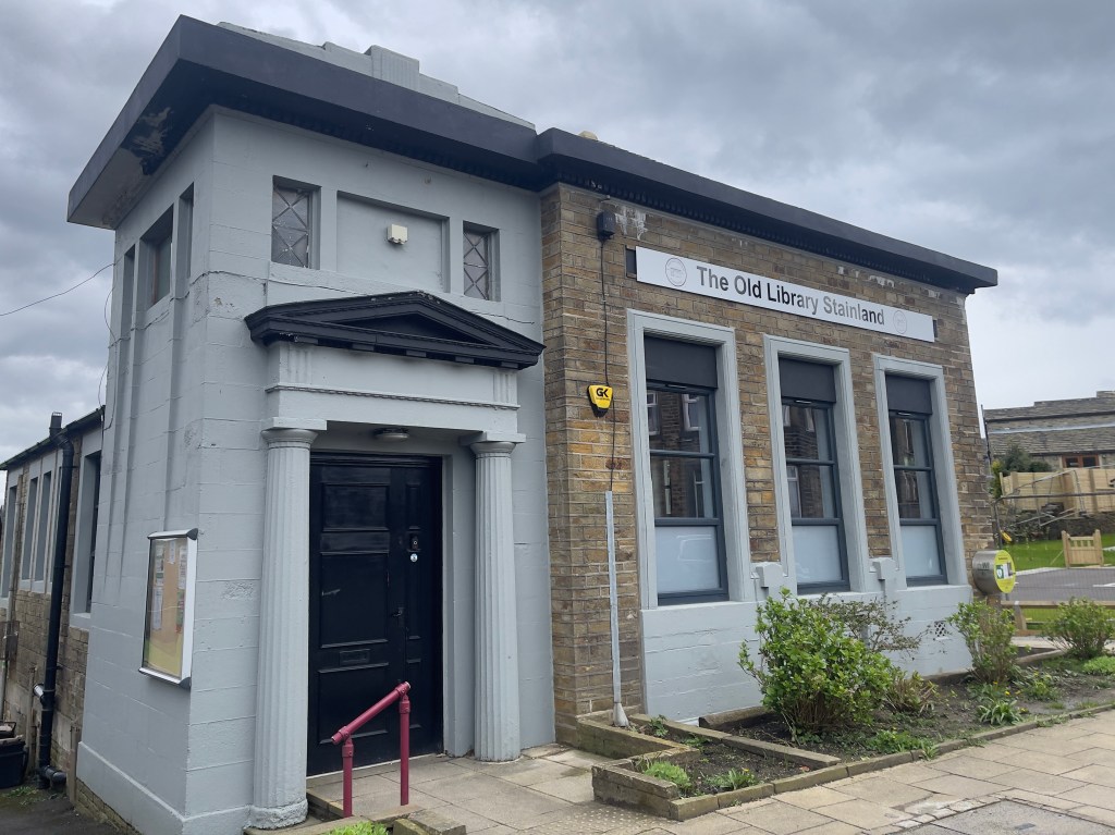 Outside the old library with signage