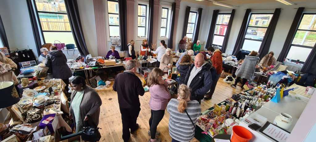Customers browse tables at the table top sale at The Old Library