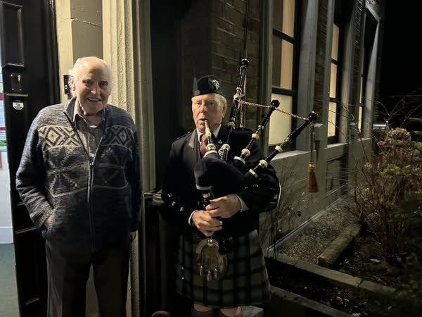 piper greets guests outside the community centre