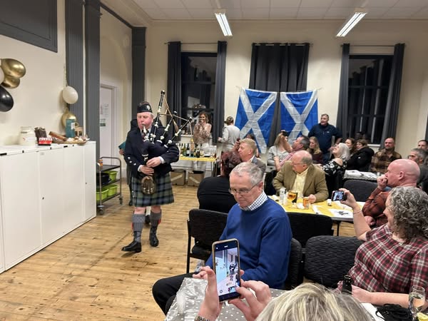 piper walks the room inside the community centre